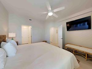 a bedroom with a white bed and a ceiling fan at Sea Glass #201 in Gulf Shores +18 photos
