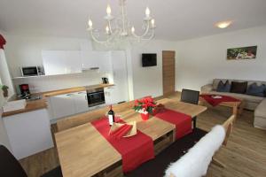 a kitchen and living room with a table and a couch at Landhaus Sporer in Aschau