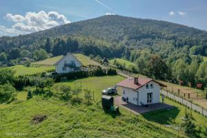 an aerial view of a house on a hill at JAWORNICA HOUSE przytulny domek w górach in Targanice