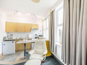 a kitchen with a chair and a table and a window at Shibden Suite - Uk38332 in Halifax