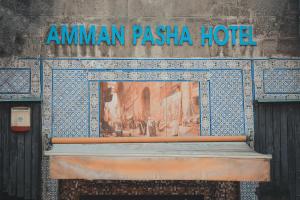 a sign for the aman pasha hotel on a building at Pasha Boutique Hotel in Amman