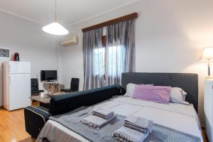 a bedroom with a large bed with two towels on it at Alice House 2 in Amarynthos +30 photos
