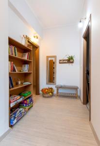 a hallway with a table and bookshelves at Alice House 2 in Amarynthos