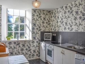 a kitchen with a sink and a microwave at Hayfield - Uk35890 in Turriff