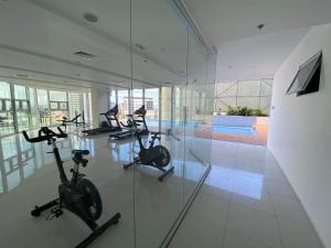 a gym with several exercise bikes in a room at Inspiria Davao in Davao City