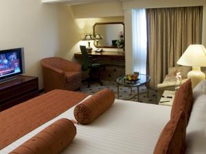 a hotel room with two beds and a television at Avari Lahore Hotel in Lahore