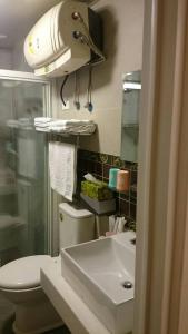 a bathroom with a toilet and a sink at Ziteng Hua Homestay in Hualien City