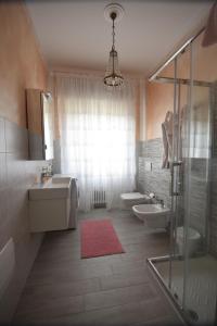 a bathroom with a sink and two toilets and a shower at Le Bouganville Apartment in Desenzano del Garda +100 photos