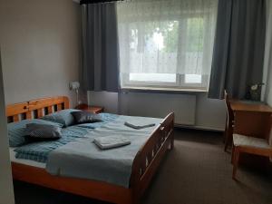 Postel nebo postele na pokoji v ubytování Hotel Olimpijski + 26 fotografií