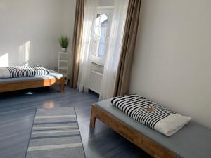 a room with two beds and a window at Ferienwohnung Birka in Speyer