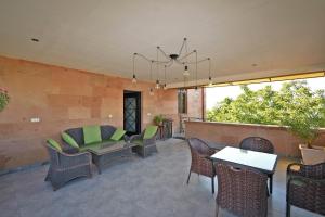 a patio with chairs and tables and a chandelier at Villa in Nork in Yerevan