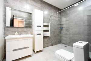 a bathroom with a toilet and a sink and a mirror at Villa in Nork in Yerevan