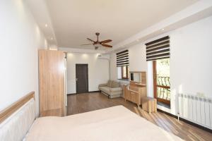 a bedroom with a bed and a ceiling fan at Villa in Nork in Yerevan