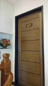 a wooden door with the number on it at Ziteng Hua Homestay in Hualien City