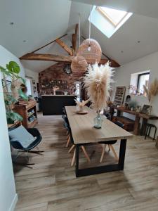 a dining room with a table and some chairs at Ravissante Suite 90m2 près des bord de Loire in Saint-Julien-de-Concelles