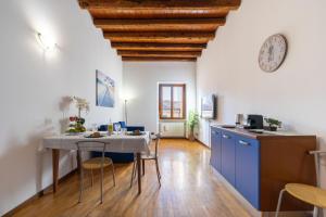 eine Küche und ein Esszimmer mit einem Tisch und einer Uhr in der Unterkunft Residenza al Corso in Verona