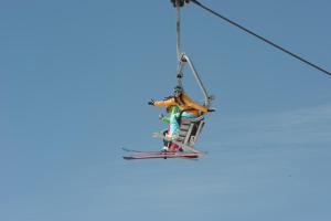 a skier is on a ski lift at Petit Arnica in Selva di Cadore