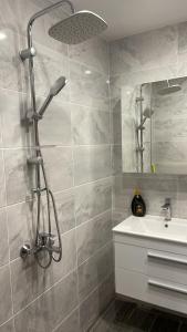 a bathroom with a shower and a sink at ORION APARTMENTS in Chepelare