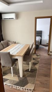 a dining room with a table and a couch at ORION APARTMENTS in Chepelare