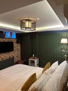 a bedroom with a white bed and a green wall at GalataCo Hotel in Istanbul