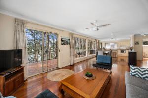 a living room with a couch and a table at Aqua Vista in Smiths Lake