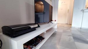 a living room with a shelf with wine bottles at Laguna Beach Paradise - Alojamientos La Torre in Torrox Costa +30 photos