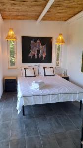 a large bed in a bedroom with two lights at Greek Island bungalow in Samos set in beautiful nature in Samos