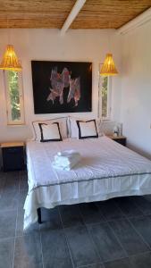 een groot bed in een kamer met 2 verlichting bij Greek Island bungalow in Samos set in beautiful nature in Samos