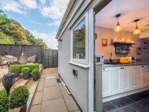 an outdoor kitchen with a view of a backyard at Riverside Cottage in Reedham