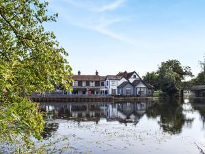 a house on the side of a body of water at Ace Lodge in Hoddesdon