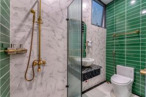 a bathroom with a shower and a toilet and a sink at Padona Hotel in Da Lat +42 photos