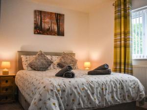 a bedroom with a bed with two stuffed animals on it at Bumblebee Lodge in Staithes