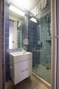 a bathroom with a sink and a shower at Royal Son Bou Family Club in Son Bou