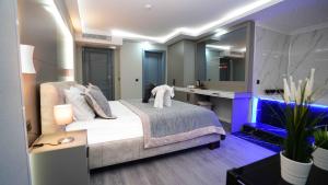 a bedroom with a bed and a sink and a mirror at AURA MARINA HOTEL in Istanbul