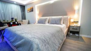 a bedroom with a large bed and a living room at AURA MARINA HOTEL in Istanbul