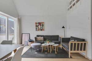 a living room with a couch and a table at Skagen Harbour Apartments in Skagen