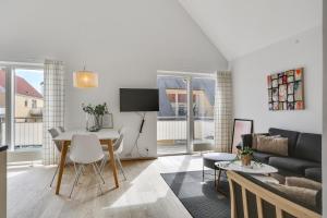 a living room with a table and a couch at Skagen Harbour Apartments in Skagen