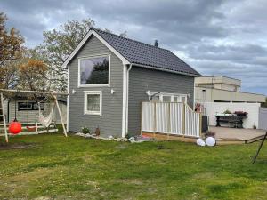 a gray house with a playground in a yard at Sauna House in Andenes