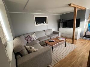 a living room with a couch and a coffee table at Sauna House in Andenes