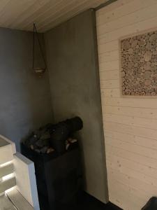 a corner of a room with a pile of logs at Sauna House in Andenes