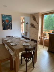 a large wooden table in a room with chairs at Chalet La Felize in Oz