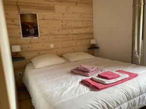 a white bed with towels on top of it at Chalet La Felize in Oz