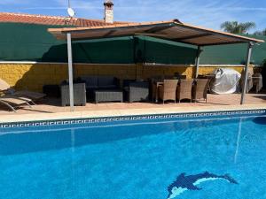 a swimming pool with a pavilion and a swimming pool at Villa Vanessa in Alhaurín de la Torre