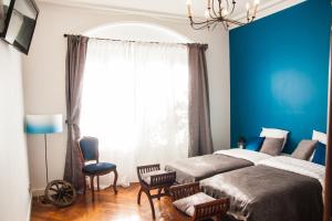 1 dormitorio con 2 camas y pared azul en Félix dOrt, en Lyon