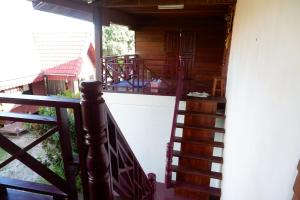 a staircase leading up to a house with a balcony at Song Lao Guesthouse in Thakhek