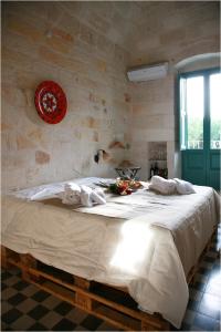 a bedroom with a large bed with towels on it at Lazzarella B&B in Polignano a Mare