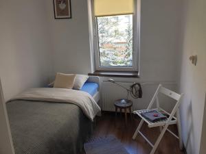 een kleine slaapkamer met een bed en een raam bij Blue River - Boleslawiecka in Wrocław