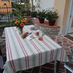 una mesa con un mantel a rayas en el patio en Appartamento GIRASOLE, Salò en Salò