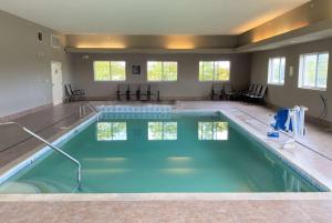 a large swimming pool in a large house at Super 8 by Wyndham Cedar Falls in Cedar Falls