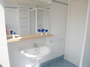 a white bathroom with a sink and a mirror at Residence Mirage in Grado